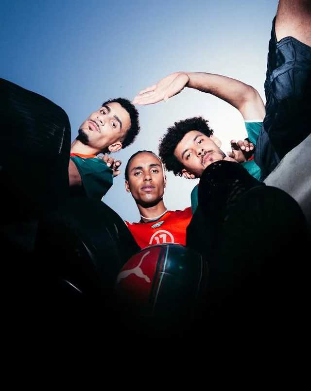 Three Morocco supporters gathered above the camera around a football