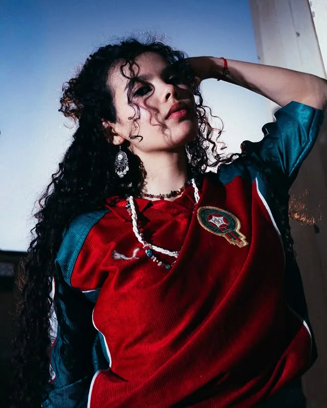 Portrait of a woman wearing a red Morocco football shirt