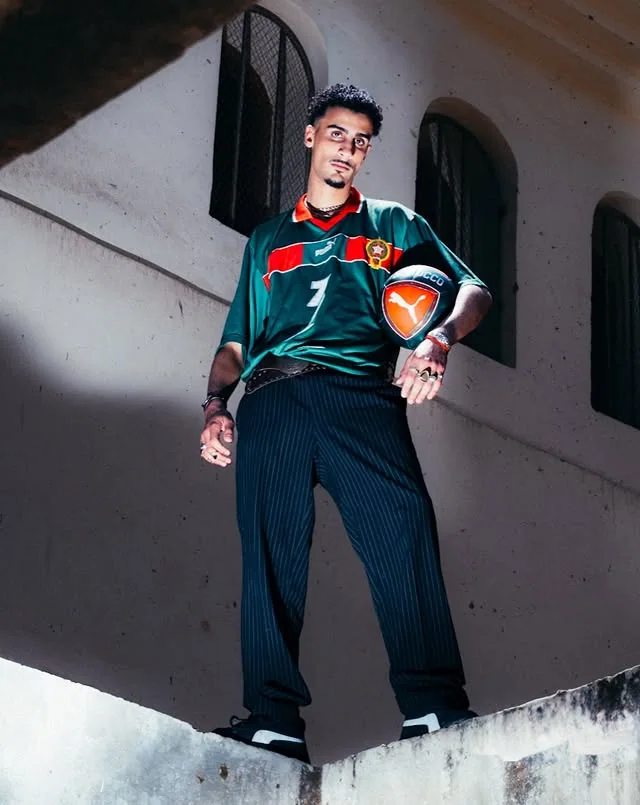 Morocco supporter standing with a football in an architectural passage