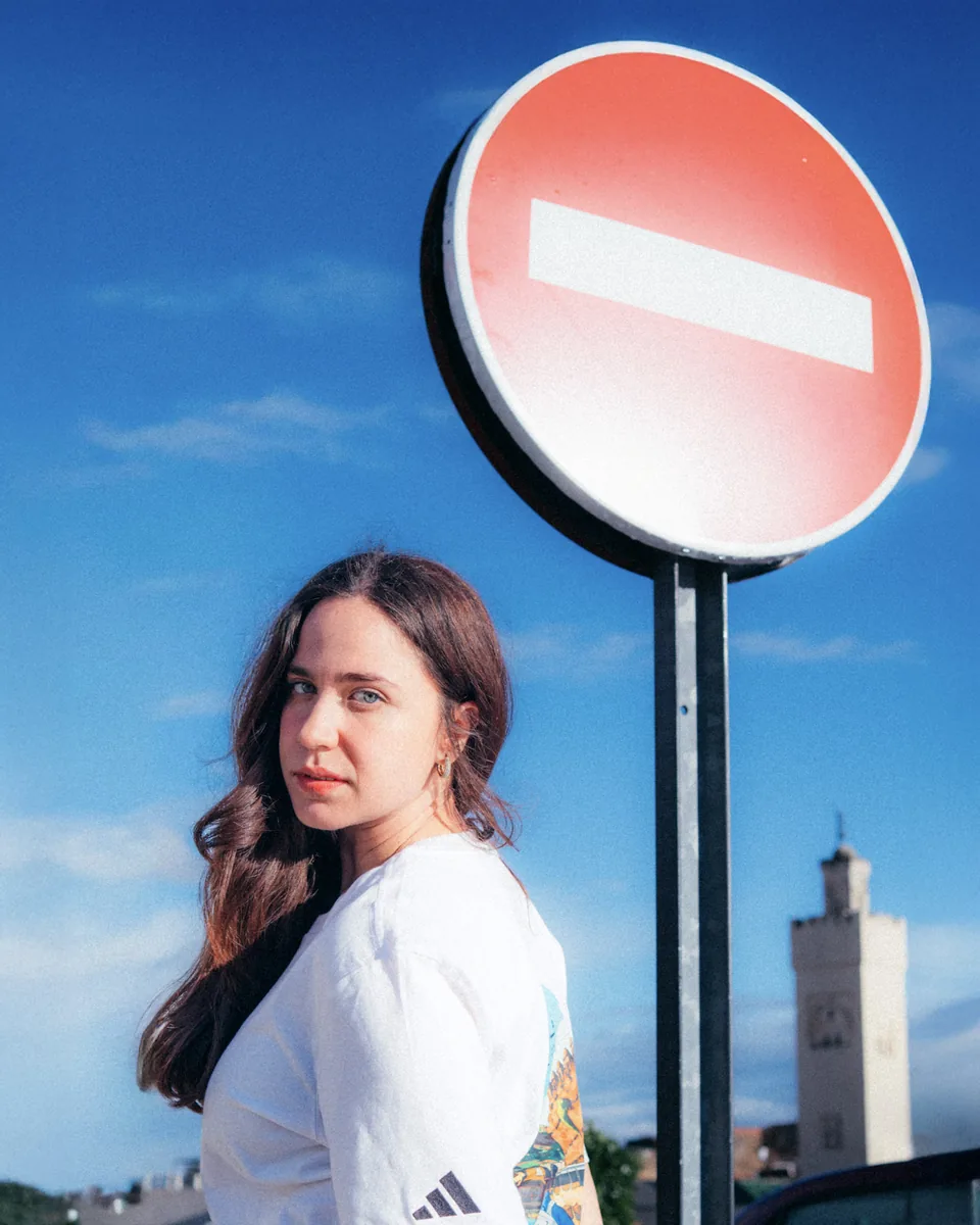 Adidas portrait beside a traffic sign