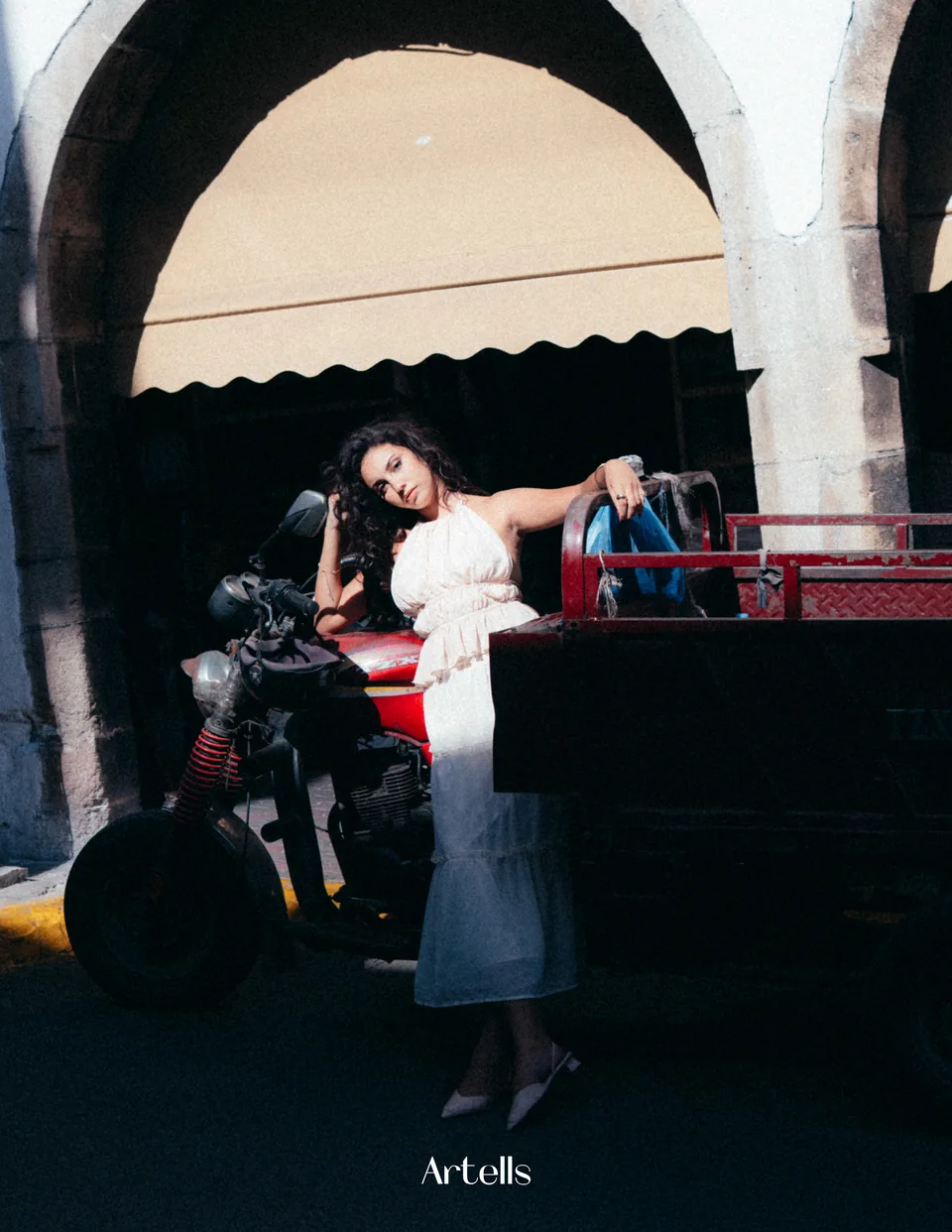 Artells fashion portrait beside a car